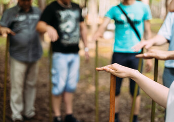 Hands of people standing and holding sticks. Team building event for rallying and teamwork. High quality photo