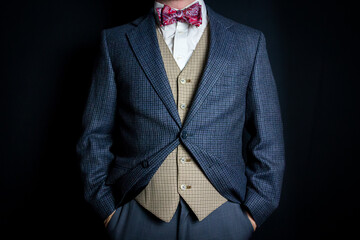 Portrait of Gentleman in Suit and Bow Tie Standing With Hands in Pockets. Vintage Style and Retro Fashion.