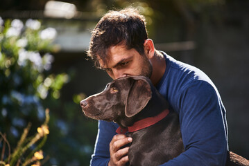 Fototapeta premium young man hugging his dog