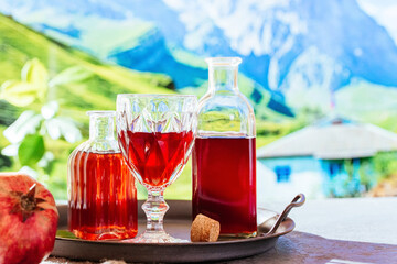 pomegranate juice and fresh pomegranate on the background of mou