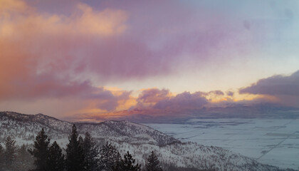 Dreamy Pastel Skies with Clouds over Snowy Mountains and Valley