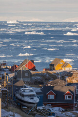 tipical artic town surrounded by big icebergs