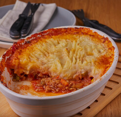 Homemade cottage pie with vegetables in filling.