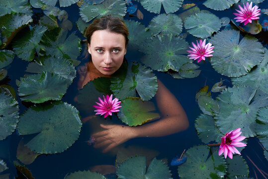 beautiful girl in the lake with lotuses