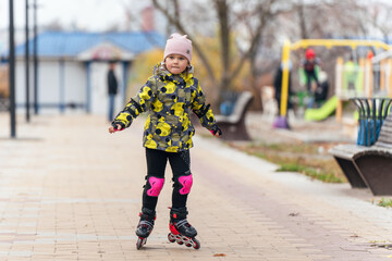 Cute little girl learning to roller skate