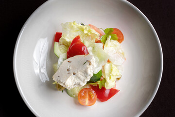 Greek salad. Fresh vegetable salad of cucumbers, tomatoes, olives, onion, bell pepper, feta cheese. Top view