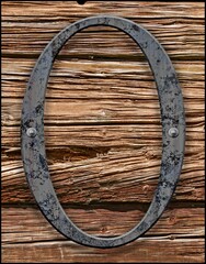 Iron letter O on old wood