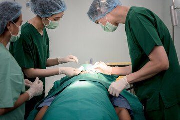 Asian doctor surgeon team, Working in the operating room, Doing nose surgery on a female patients,...