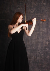 Beautiful redheaded girl playing the violin