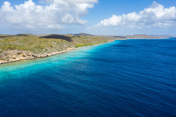 Aerial view of the coast of Curaçao in the Caribbean with beach, cliff, and turquoise ocean