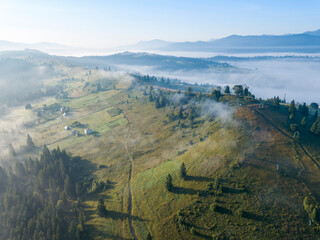 Morning mist in Ukrainian Carpathian mountains. Aerial drone view.