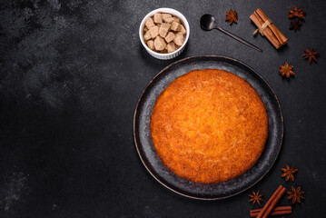 Pumpkin pie on marble cutting board. Dark background. Copy space