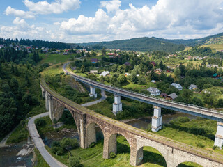 Old railway bridge in the mountains. Ukrainian Carpathians. Aerial drone view.