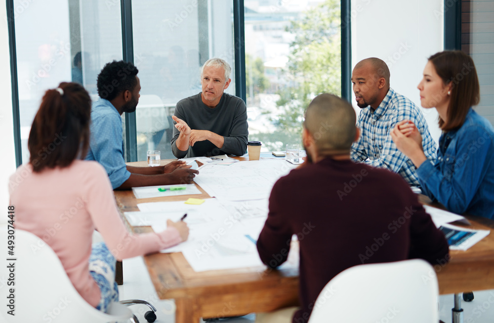 Poster theyll turn your dreams into reality. cropped shot of a group of architects in the boardroom.