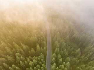 Mountain road in the fog. Aerial drone view.