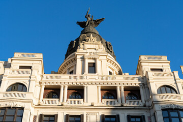 Fototapeta na wymiar Historic building with sculpture on top designed in 1928 in Bilbao city