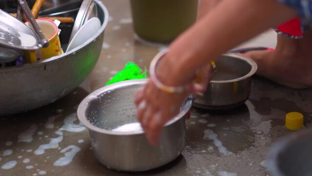 Close up shot of female hands cleaning kitchen utensils with dishwashing soap. Washing kitchen utensils. Housekeeping and domestic life conceopt