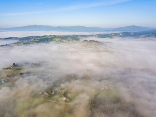 Morning mist in Ukrainian Carpathian mountains. Aerial drone view.