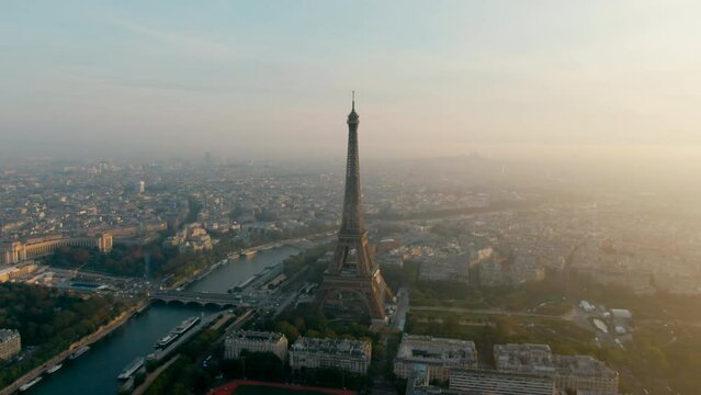 Establishing Aerial shot of Paris Cityscape with Eiffel Tower, France. Landmark Monument as Famous Touristic Destination. Romantic Travel and Urban Skyline Panorama. 4K drone view