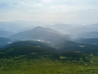 Fototapeta premium High mountains of the Ukrainian Carpathians in cloudy weather. Aerial drone view.