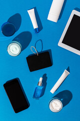 Skin care cosmetics protecting from gadgets blue light on blue background