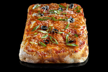 Pizza with cheese, olives and green onions. On a black isolated background.