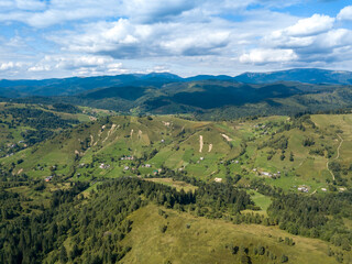 Obraz premium Green mountains of Ukrainian Carpathians in summer. Coniferous trees on the slopes. Aerial drone view.