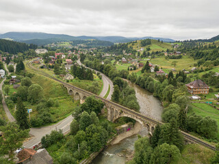 Old railway bridge in the mountains. Ukrainian Carpathians. Aerial drone view.