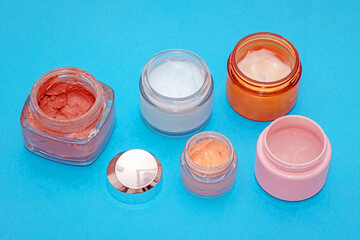 Open glass jars with beauty creams