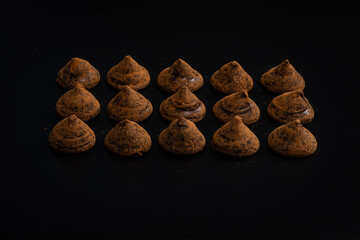 Chocolate truffles on a black background.