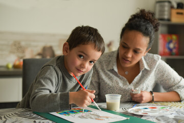 metis mother doing painting with her son