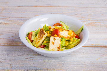 There is cheese in a vegetarian salad with sauce, prepared with special ingredients