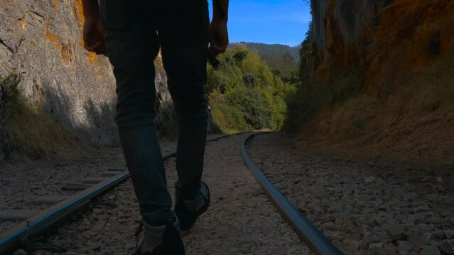 Rock climber walking on the Suesca train tracks