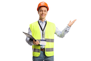 Construction site engineer wearing a reflective vest and helmet and showing with hand
