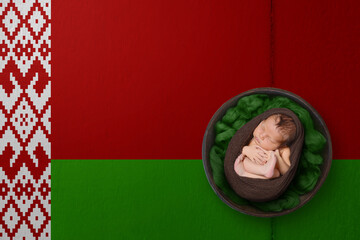 Newborn portrait on background in color of national flag. Patriotic photography concept. Belarus