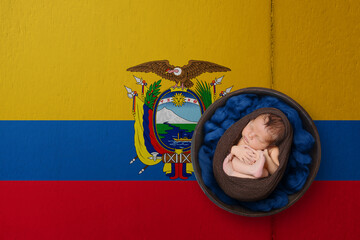 Newborn portrait on background in color of national flag. Patriotic photography concept. Ecuador