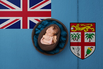 Newborn portrait on background in color of national flag. Patriotic photography concept. Fiji