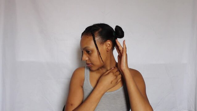 Young African Woman fixing her natural 4c hair on a white background