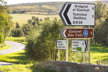 Sign for Glenlivet Bike Trails and Tomintoul Distillery at Bridge of Avon, near Tomintoul, Moray,...