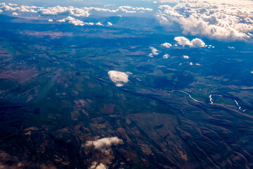 Aircraft wing view from airplane window seat. Beautiful sky and cloud.
