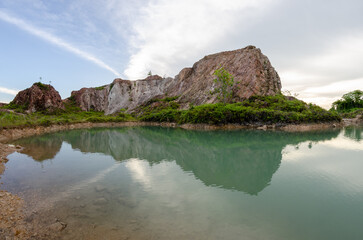 Fototapeta na wymiar Reflection of abandoned quarry hill