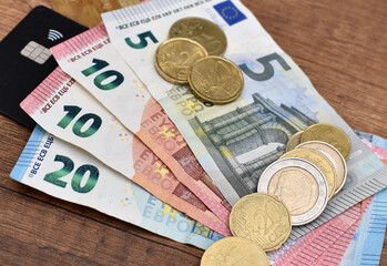euro bills 20, 10, 5, credit card and iron coins
