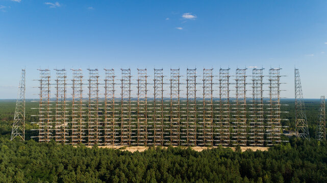 Aerial view of the DUGA radar station near the city of Chernobyl-2 among the forest in sunny day. Drone shot Chernobyl exclusion zone in summer. Radiation