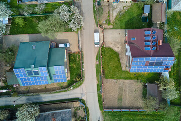 Private home roof covered with solar photovoltaic panels for generating of clean ecological electric energy in suburban rural town area. Concept of autonomous house