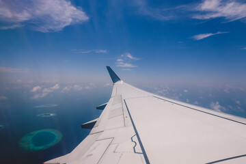 Fototapeta na wymiar Aerial View from Aircraft Window to the Male Island among the Blue Indian Ocean, Republic of Maldives