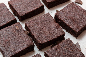 Slices of brownie dessert on a light background
