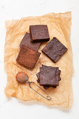 Slices of brownie dessert on a light background
