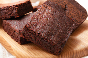 Slices of brownie dessert on a light background
