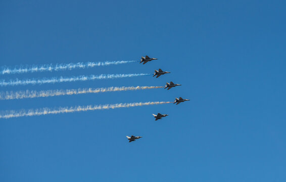 Group of aircrafts  flying with color smoke in blue sky under the Kiev during the parade on the occasion of 30 years of independence of Ukraine, august 2021