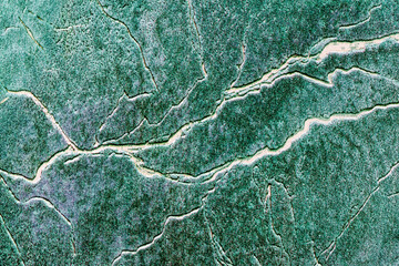 background surface texture in various shades of green covered with irregular lines